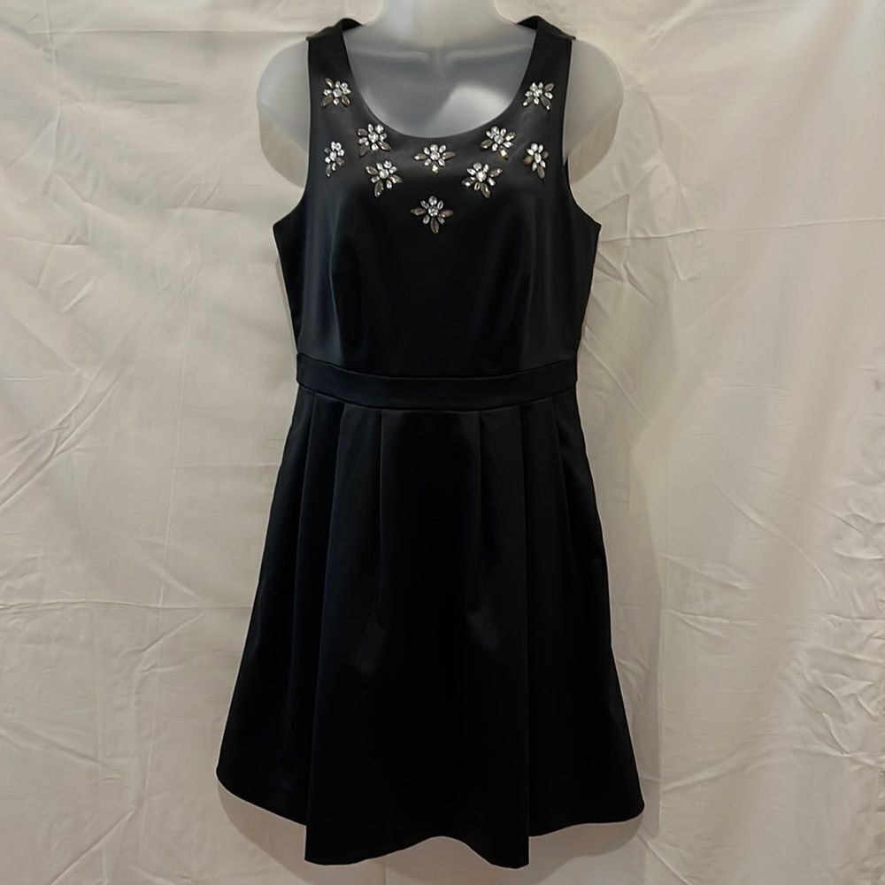 - - The limited black sleeves formal dress with  jeweled at neck. Size 6.